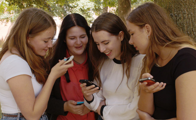 Image: Girls with phones outside