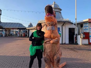 Two students from Sussex Men's Rugby Club pose in fancy dress by Brighton Palace Pier, as part of a charity fun run.