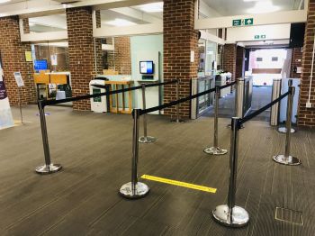 Library entry gates, three queue barriers set up inside the entry gates of Sussex Library