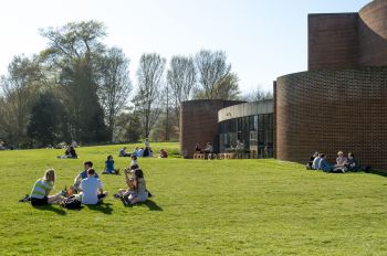 People sitting on grass near ACCA