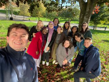 Graduate Connectors & the SEE team smiling together underneath a tree on campus