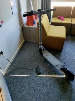 e-scooter being charged in a residence hall