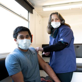 Student getting his Covid-19 vaccine shot