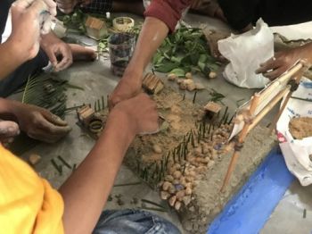 Children during a workshop sculpting and creating a model of nature