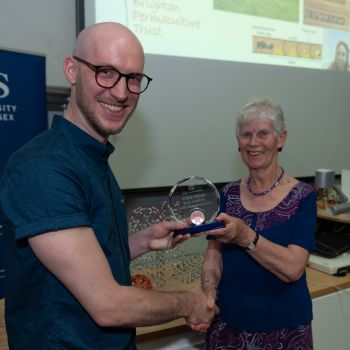 Lady Margaret Kroto presenting the glass trophy to Dr Sergio Rossoni