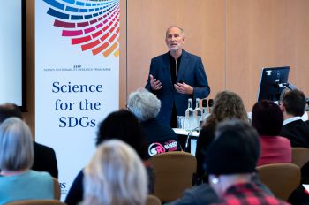 Joe Alcamo giving a presentation on delivering science for the Sustainable Development Goals. He is pictured standing in front of an audience