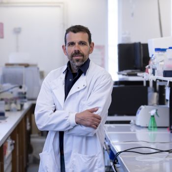 Georgios Giamas, Professor of Cancer Cell Signalling in his lab wearing his lab coat
