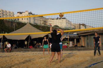 Woman returns serve at 2023 Staff Volleyball Tournament