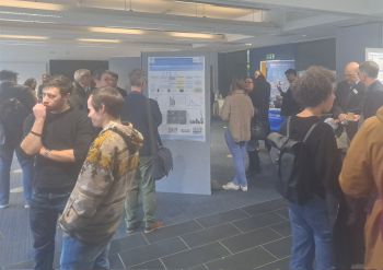 People browsing research posters at the symposium