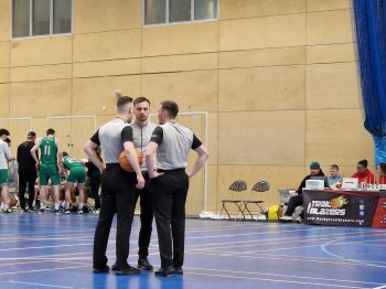A team of three young basketball referees
