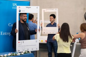 students posing with selfie frames