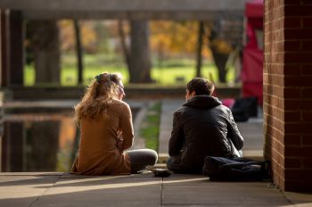 Two postgraduates sitting and talking