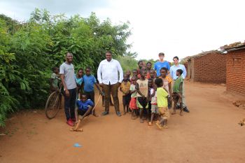 Dexter, another volunteer and two postgrad students who attended the course surrounded by kids in one of the villages