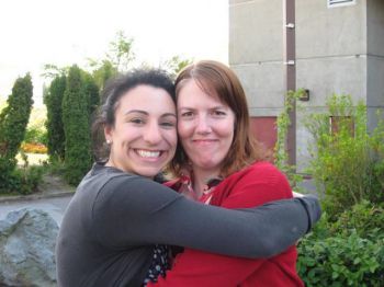 The two psychologists behind the research, Dr Gillian Sandstrom and Prof Lara Aknin with their arms around each other.