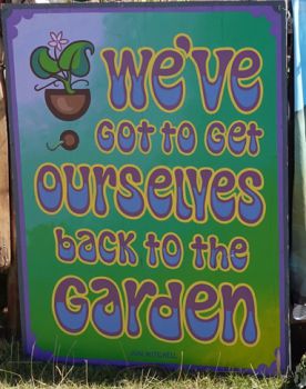 Sign with an image of an unpotted plant and a quote from a Joni Mitchell song reading