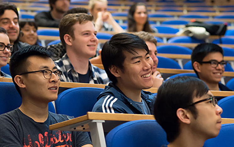 Students smiling and enjoying a lecture