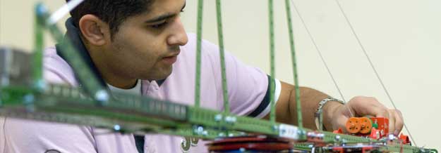 Student in building model bridge