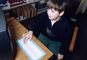 photo of child using computer