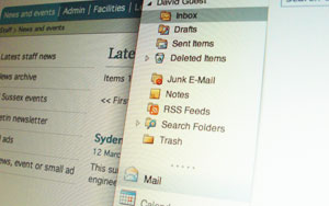 close-up of screen showing Outlook inbox in front of US logo