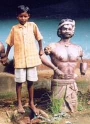 Kanhu Murmu, with statue of his ancestor, rebellion leader Kanhu Murmu