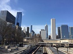 View of downtown Chicago from the highway. Skyscrapers loom into view.