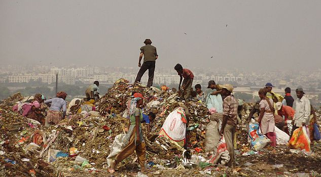People sorting through waste in India