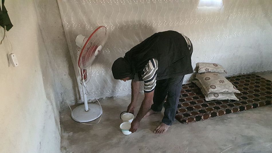woman in a home in Syria