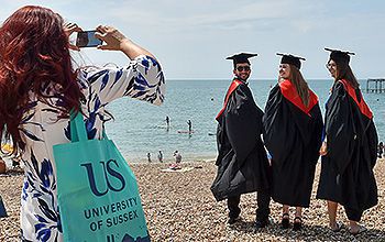 Students celebrating their graduation on Brighton seafront