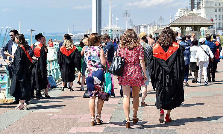 A group walk away from the Brighton Centre after a ceremony