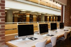 a row of apple computers in the Library
