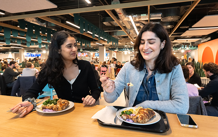Two students enjoying a meal in Eat Central