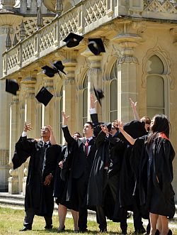 Graduating students throw mortar boards in air