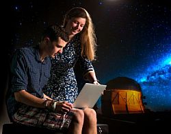 Dr Marisa March and one of her team of "eyeballers", physics student Rhys Poulton, who helped test-run images for the Dark Energy Survey. Image: Stuart Robinson