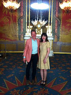 Alexandra (right) Michael (left). Standing in colourful room in the royal pavillion.