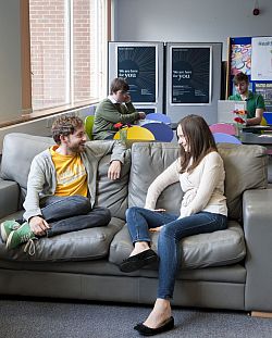 Students chatting on sofa