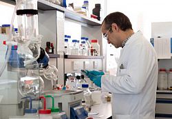 A researcher in a lab, surrounded by scientific equipment