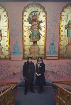 A photo of Alexandra Loske and Lu Peng on a staircase inside the Royal Pavilion