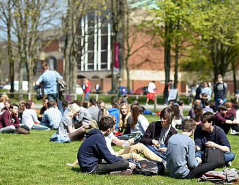 Visitors to the UCAS Convention sitting outside enjoying the nice weather on campus