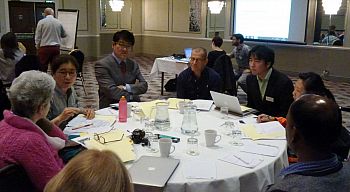 A table of attendees talk at the Centre for Bionetworking's workshop