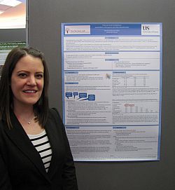 A photo of Alexandra Earl next to her JRA poster