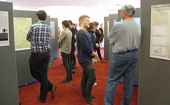 A photo of some people looking at posters at the JRA poster exhibition 2015