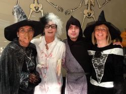 Four catering staff standing in a row dressed in Halloween outfits