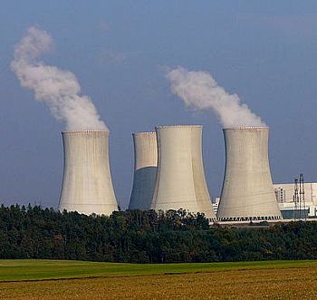 A photo of a nuclear power plant, its towers steaming