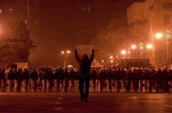 A protestor with his arms aloft in Tahrir Square, Egypt
