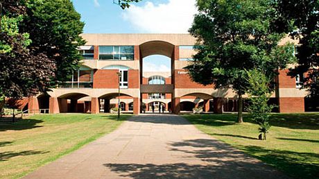 Picture of the entrance of University of Sussex. It is a modernist building using red bricks.