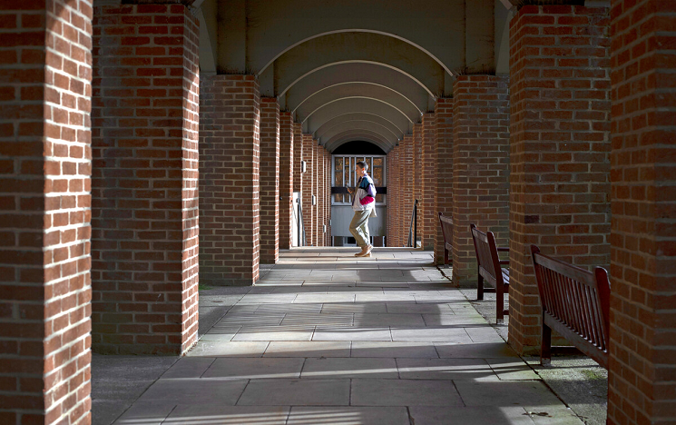 student walking towards Arts buildings_