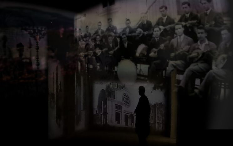 A digital collage of images of pre-war Jewish life projected onto the inside walls of Block 27 at Auschwitz I