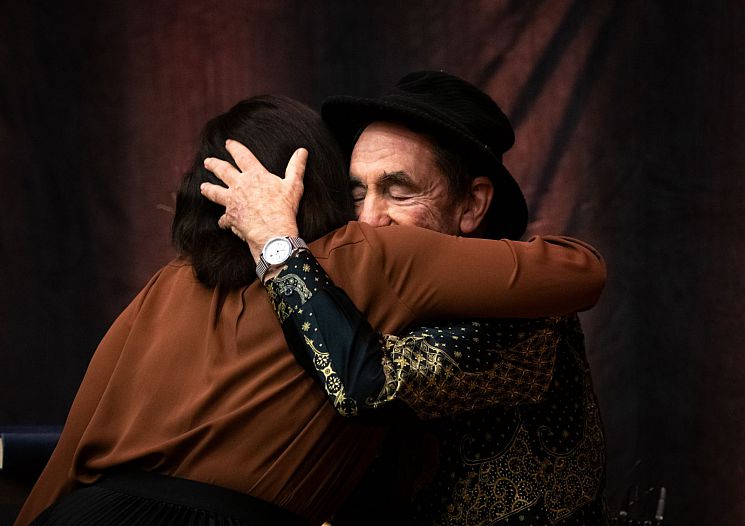 Mpinane, a South African student at Sussex, hugs Albie Sachs more than 30 years after he gained his PhD at Sussex as an exiled South African.