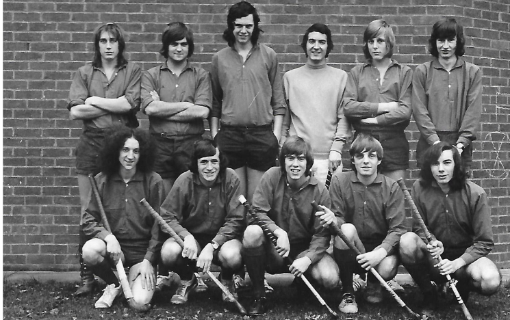 The First XI hockey team from 1972. Pictured are 6 students standing with 5 students stood in front holding hockey sticks.