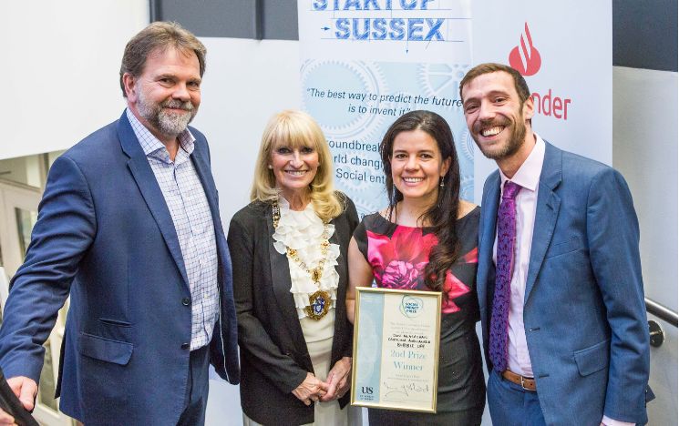 From left to right, Mike Herd from the Sussex Innovation Centre, the Mayor of Brighton and Hove Councillor Jackie O'Quinn, Carolina Avellaneda holding the 2nd prize for Social Impact by the Sussex Innovation Centre and the University of Sussex and Jon McGlashan smiling.